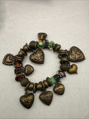 Brassy heart charm bracelet needs restring sold as is wear until break or parts